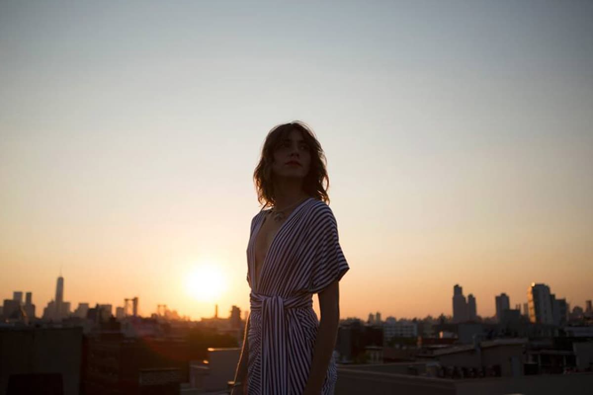 Woman looking over the Rio de Janeiro skyline at sunset